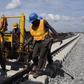 Men work on a train track at the National Arts Theatre stop of the light rail system under construction in Lagos, Nigeria, May 30, 2014.    REUTERS/Joe Penney