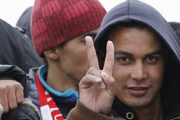 Moroccan citizen Touil Abdelmajid makes a victory sign as he arrives with migrants on the Italian navy ship Orione at Porto Empedocle harbour in Sicily February 17, 2015. Italian police said on May 20, 2015 they had arrested the 22-year-old Moroccan ma...