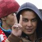 Moroccan citizen Touil Abdelmajid makes a victory sign as he arrives with migrants on the Italian navy ship Orione at Porto Empedocle harbour in Sicily February 17, 2015. Italian police said on May 20, 2015 they had arrested the 22-year-old Moroccan ma...