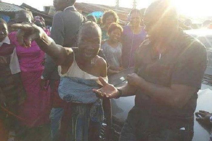 Gov Ayo Fayose listens in rapt attention to the old woman