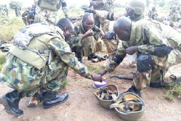 Soldiers sharing their food together