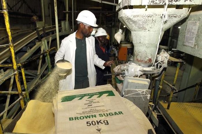 A worker weighs and packs bags of sugar at the Mumias sugar factory in western Kenya February 24, 2015. REUTERS/Thomas Mukoya