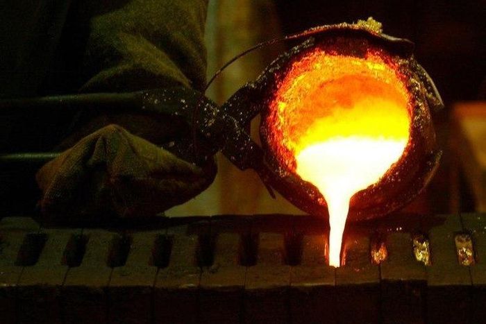 Refined gold is poured into moulds to be made into gold bars at South Africa's Rand Refinery in Germiston in a file photo. REUTERS/Siphiwe Sibeko