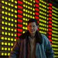 An investor walks past an electronic screen showing stock information at brokerage house in Nanjing, Jiangsu Province, China, January 11, 2016. REUTERS/China Daily