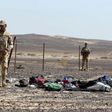 Egyptian army soldiers collect belongings of passengers from the crash site of a Russian airliner at the Hassana area in Arish city, north Egypt, November 1, 2015.
