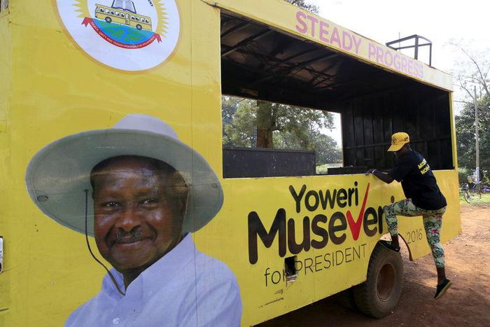 A woman gets off a truck with pictures of National Resistance Movement (NRM) party candidate Yoweri Museveni in Masindi town January 23, 2016 ahead of the February 18 presidential election. REUTERS/James Akena