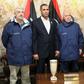 Tripoli-based Libyan Foreign Minister Ali Abu Zakouk (R) stands with Gino Pollicardo (L) and Filippo Calcagno (2nd R), two Italian civilians held hostage near the western Libyan city of Sabratha since last July, after they were freed, at Mitiga Interna...