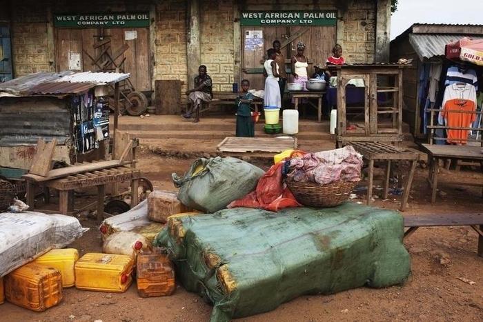 Containers of palm oil lie in front of a store in the town of Kailahun in eastern Sierra Leone April 23, 2012. The U.N. war crimes court trying Charles Taylor for atrocities in Sierra Leone will deliver its verdict on Thursday. Sierra Leone's 11-year c...