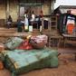 Containers of palm oil lie in front of a store in the town of Kailahun in eastern Sierra Leone April 23, 2012. The U.N. war crimes court trying Charles Taylor for atrocities in Sierra Leone will deliver its verdict on Thursday. Sierra Leone's 11-year c...