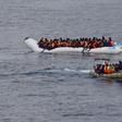 Migrants sit in their boat during a rescue operation of 219 migrants by Italian naval vessel Bettica (not seen) in this February 23, 2016 handout picture provided by Marina Militare. REUTERS/Marina Militare/Handout via Reuters