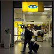 Travellers walk past an MTN telecom shop at King Shaka International Airport in Durban, South Africa, November 16, 2015.   REUTERS/Rogan Ward