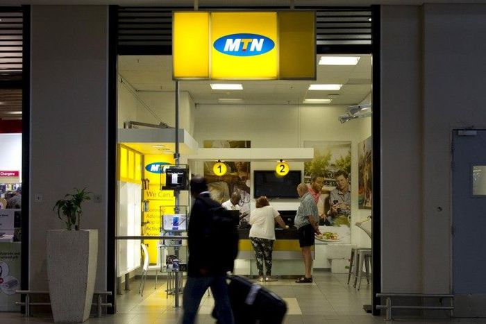 Travellers walk past an MTN telecom shop at King Shaka International Airport in Durban, South Africa, November 16, 2015.   REUTERS/Rogan Ward