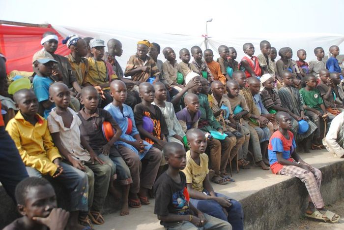 Homeless persons gather to watch a local wrestling match