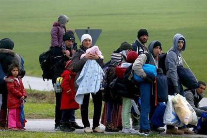 Migrants rest after crossing the Austrian-German border in Wegscheid near Passau, Germany, October 20, 2015.