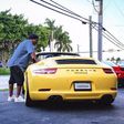 Ronaldinho poses with his Porsche Carrera
