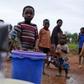 Children watch as women pump water from a borehole near Malawi's capital Lilongwe, February 2, 2016. REUTERS/Mike Hutchings