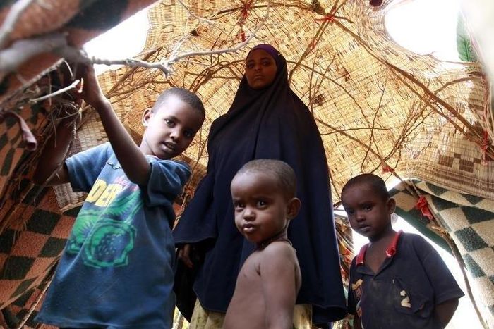 An internally displaced family stands inside their makeshift shelter structure at the Qansahaley settlement camp in Dollow town along the Somalia-Ethiopia border, August 30, 2011.  REUTERS/Thomas Mukoya