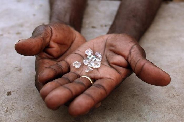An illegal diamond dealer from Zimbabwe displays diamonds for sale in Manica, near the border with Zimbabwe, September 19, 2010. REUTERS/Goran Tomasevic