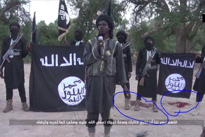Screen shot from Boko Haram video showing amputation of two men's hands