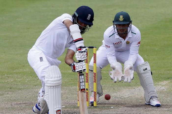 England's Moeen Ali plays a shot as South Africa's Quinton de Kock looks on during the second cricket test match in Cape Town, South Africa, January 6, 2016. REUTERS/Mike Hutchings