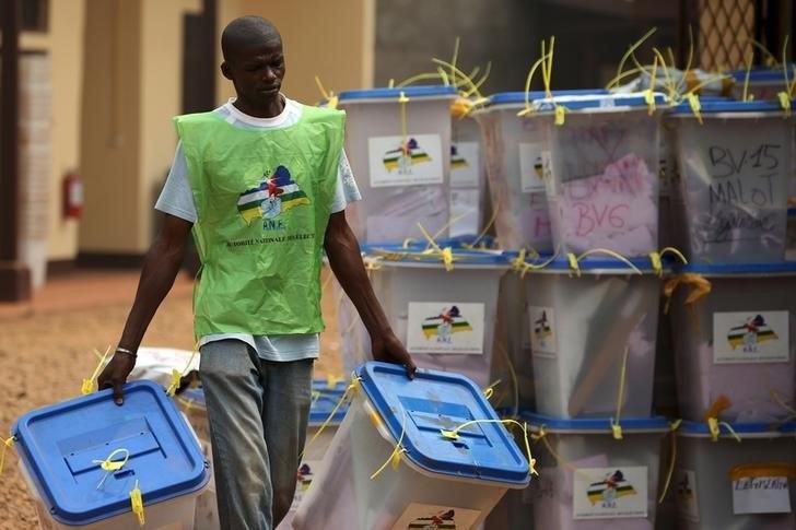 An electoral official carries ballot boxes in a warehouse used as an official centre used to keep votes from the last second round of presidential and legislative elections, Bangui, Central African Republic, February 16, 2016. REUTERS/Siegfried Modola