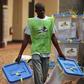 An electoral official carries ballot boxes in a warehouse used as an official centre used to keep votes from the last second round of presidential and legislative elections, Bangui, Central African Republic, February 16, 2016. REUTERS/Siegfried Modola
