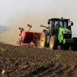 A man stands on a planter towed by a tracter during seeds planting in a field at Amatheon Agri farm in Nwoya district in northern Uganda, July 16, 2015. Picture taken July 16, 2015. REUTERS/James Akena
