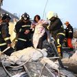 Rescue personnel help a victim at a damaged building after an earthquake in Tainan, southern Taiwan, February 6, 2016.