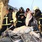 Rescue personnel help a victim at a damaged building after an earthquake in Tainan, southern Taiwan, February 6, 2016.