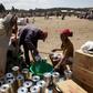 An elderly woman receives cooking oil at an emergency food aid distribution in the village of Estayish in Ethiopia's northern Amhara region, February 11, 2016. REUTERS/Katy Migiro
