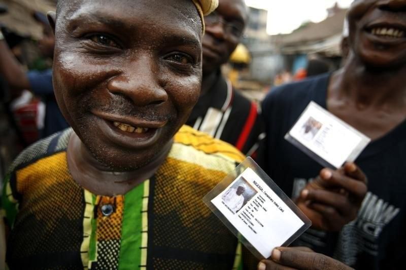Nigerian voters show off their identity cards while lining up to vote in the neighbourhood of Isale-Eko in in a file photo. REUTERS/Finbarr O'Reilly