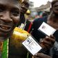 Nigerian voters show off their identity cards while lining up to vote in the neighbourhood of Isale-Eko in in a file photo. REUTERS/Finbarr O'Reilly