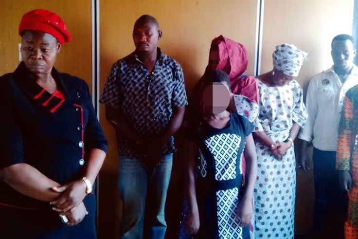 Assana in the middle and her brother second left standing with other suspects