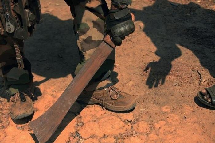 A French soldier takes a machete away from resident in Bossangoa, north of the capital Bangui, January 2, 2014. REUTERS/Andreea Campeanu