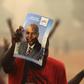 Supporters of presidential candidate Faustin-Archange Touadera holds a poster during a campaign in Bangui, Central African Republic, February 12, 2016. REUTERS/Siegfried Modola