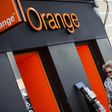 A woman walks past an Orange shop in Madrid, September 16, 2014. REUTERS/Andrea Comas