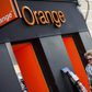 A woman walks past an Orange shop in Madrid, September 16, 2014. REUTERS/Andrea Comas