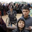 Syrian refugees stand in line as they wait for aid packages at Al Zaatari refugee camp in the Jordanian city of Mafraq, near the border with Syria, January 20, 2016. REUTERS/ Muhammad Hamed