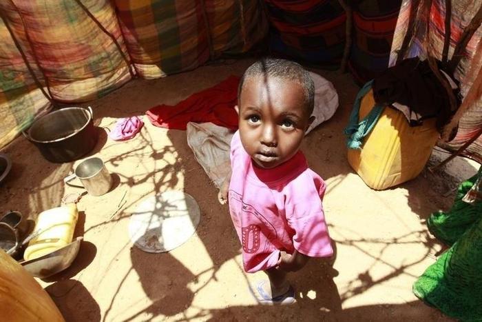 A displaced child stands inside their makeshift shelter structure at the Qansahaley settlement camp in Dollow town, along the Somalia-Ethiopia border, August 30, 2011. REUTERS/Thomas Mukoya