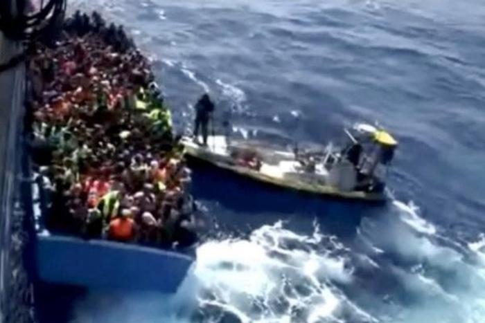 A boat full of migrants is seen next to Swedish ship Poseidon during a rescue operation in the sea off the coast of Libya in this still image taken from an August 26, 2015 video. REUTERS/Swedish Coast Guard Handout via Reuters TV -