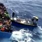 A boat full of migrants is seen next to Swedish ship Poseidon during a rescue operation in the sea off the coast of Libya in this still image taken from an August 26, 2015 video. REUTERS/Swedish Coast Guard Handout via Reuters TV -