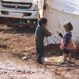 Children play outside tents housing internally displaced people in Atma camp, near the Syrian-Turkish border in Idlib Governorate, February 5, 2016.