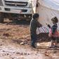 Children play outside tents housing internally displaced people in Atma camp, near the Syrian-Turkish border in Idlib Governorate, February 5, 2016.