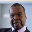 Zimbabwe's Reserve Bank Governor John Mangudya gestures while responding to questions in the country's parliament in Harare June 30, 2014. REUTERS/Philimon Bulawayo