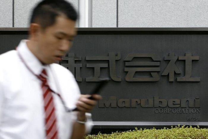 A man walks past a sign of Japanese general trading company Marubeni Corp at the company's head office in Tokyo July 27, 2009. REUTERS/Stringer