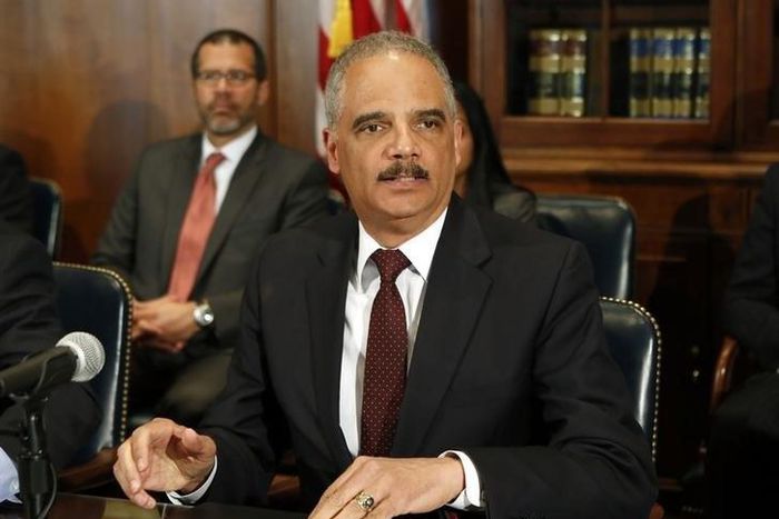 Former U.S. Attorney General Eric Holder talks to the media in Washington March 12, 2015. REUTERS/Yuri Gripas