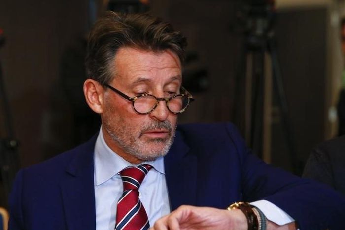 Sebastian Coe, IAAF's President, checks time ahead of a news conference by the World Anti-Doping Agency's (WADA) former president, Dick Pound, who heads the commission into corruption and doping in athletics, in Unterschleissheim near Munich, Germany, ...
