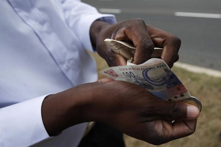 A man   counts South African rand notes in a file photo. REUTERS/Michael Buholzer