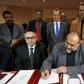United Nations Special Representative and Head of the U.N. Support Mission in Libya Martin Kobler (C, top) looks on as representatives of Libyan municipalities sign documents to support Libya's new national government during a meeting in Tunis, Tunisia...