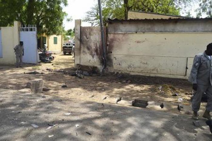 Security officers stand next to the site of a suicide bombing in Ndjamena, Chad, June 15, 2015.